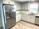 Modern kitchen with stainless steel appliances and light gray cabinets at 28 Castaway Ct, North Port, FL 34287