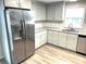 Modern kitchen with stainless steel appliances and light gray cabinets at 28 Castaway Ct, North Port, FL 34287