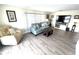 Spacious living room with ample seating and large TV at 28 Castaway Ct, North Port, FL 34287