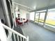 Covered patio with seating area and screens at 28 Castaway Ct, North Port, FL 34287