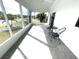 Relaxing screened porch with patio furniture and view of landscaping at 28 Castaway Ct, North Port, FL 34287