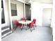 Screened porch with table and chairs, great for relaxing at 28 Castaway Ct, North Port, FL 34287