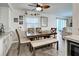 Spacious dining area with table, bench, and chairs, open to living room at 3022 Audubon Ave, Englewood, FL 34224