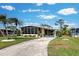 Mobile home with a landscaped yard and driveway at 3022 Audubon Ave, Englewood, FL 34224