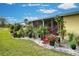 Landscaped side yard with tropical plants and white rock border at 3022 Audubon Ave, Englewood, FL 34224