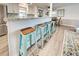 View of kitchen island with teal stools and breakfast bar at 3022 Audubon Ave, Englewood, FL 34224