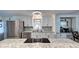Modern kitchen with stainless steel appliances and granite countertops at 3022 Audubon Ave, Englewood, FL 34224