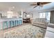 Bright living room with comfy sofas, large area rug, and ceiling fan at 3022 Audubon Ave, Englewood, FL 34224