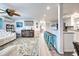 Open living room and kitchen with light flooring and teal accents at 3022 Audubon Ave, Englewood, FL 34224