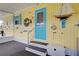 Porch with teal door and nautical-themed decor at 3022 Audubon Ave, Englewood, FL 34224
