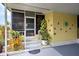 Covered porch with colorful decor and potted plants at 3022 Audubon Ave, Englewood, FL 34224