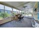 Relaxing screened porch with seating area and ceiling fan at 3022 Audubon Ave, Englewood, FL 34224