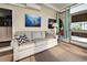Sunroom with a comfortable sofa and ocean-themed artwork at 3022 Audubon Ave, Englewood, FL 34224
