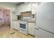 White appliances and cabinets in this galley-style kitchen at 3036 Audubon Ave, Englewood, FL 34224