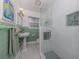 Updated bathroom with a glass shower and green tile at 321 Pedro St, Venice, FL 34285