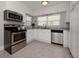 Kitchen with white cabinets, stainless steel appliances, and granite countertops at 321 Pedro St, Venice, FL 34285