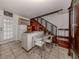 Small kitchenette with white cabinets and wood stairs at 321 Pedro St, Venice, FL 34285