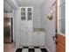 White cabinets and checkerboard floor in the laundry area at 321 Pedro St, Venice, FL 34285