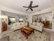 Spacious living room with hardwood floors, comfortable seating, and a view into the dining area at 321 Pedro St, Venice, FL 34285