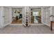 Bright living room features hardwood floors, fireplace, and French doors at 321 Pedro St, Venice, FL 34285
