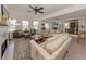 Open living area with multiple seating arrangements, fireplace, and tile floors at 321 Pedro St, Venice, FL 34285