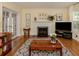 Living room with hardwood floors, fireplace, and large windows at 321 Pedro St, Venice, FL 34285