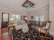 Bright sitting room with hardwood floors, comfy seating, and a rocking chair at 321 Pedro St, Venice, FL 34285