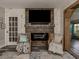 Rustic fireplace with built-in shelving and a large TV at 335 Englewood Isles Pkwy # 55, Englewood, FL 34223