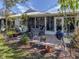 Relaxing patio with wicker furniture, grill, and lush landscaping at 335 Englewood Isles Pkwy # 55, Englewood, FL 34223