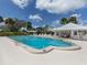 Community pool with lounge chairs and a clubhouse at 335 Englewood Isles Pkwy # 55, Englewood, FL 34223