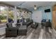 Relaxing sunroom with wicker furniture and tranquil beach mural at 335 Englewood Isles Pkwy # 55, Englewood, FL 34223