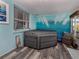 Sunroom with hot tub and calming beach-themed mural at 335 Englewood Isles Pkwy # 55, Englewood, FL 34223