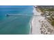 Expansive aerial view of the beach featuring white sands, blue water, and the pier at 335 Sunset Lake Blvd, Venice, FL 34292