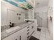 Bright bathroom featuring double sinks, a glass shower enclosure, and modern fixtures at 335 Sunset Lake Blvd, Venice, FL 34292