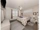 Comfortable bedroom with a ceiling fan, natural lighting, and calm decor at 335 Sunset Lake Blvd, Venice, FL 34292
