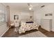 Comfortable bedroom with a ceiling fan, natural lighting, and calm decor at 335 Sunset Lake Blvd, Venice, FL 34292
