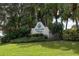 Waterside Village community sign surrounded by lush tropical landscaping, including palm trees and flowering bushes at 335 Sunset Lake Blvd, Venice, FL 34292