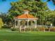 Charming gazebo nestled in a lush, green lawn, perfect for relaxation and outdoor enjoyment at 335 Sunset Lake Blvd, Venice, FL 34292