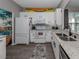 Modern kitchen with white cabinetry, granite countertops, and stainless steel appliances at 335 Sunset Lake Blvd, Venice, FL 34292