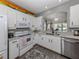 Bright kitchen features white cabinets, granite countertops, stainless steel appliances, and backsplash at 335 Sunset Lake Blvd, Venice, FL 34292