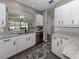 Bright kitchen features white cabinets, granite countertops, stainless steel appliances, and backsplash at 335 Sunset Lake Blvd, Venice, FL 34292