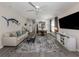 Inviting living room featuring hardwood floors, neutral tones, and a view of the dining area at 335 Sunset Lake Blvd, Venice, FL 34292