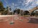 A splash pad with jets of water and a shaded seating area at 335 Sunset Lake Blvd, Venice, FL 34292