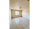 Bright bedroom with tile flooring and large window at 3400 Rain Lily, Englewood, FL 34224
