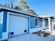 House exterior boasts a blue painted exterior and attached garage at 3400 Rain Lily, Englewood, FL 34224