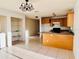 Kitchen boasts wood cabinets, granite island, and breakfast bar at 3400 Rain Lily, Englewood, FL 34224