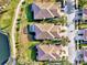 Aerial view of three houses with tile roofs and landscaping at 4259 Whispering Oaks Dr, North Port, FL 34287