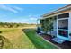 Spacious backyard with grassy area and screened patio at 4259 Whispering Oaks Dr, North Port, FL 34287