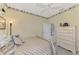 Serene bedroom with a dresser and access to the kitchen at 4259 Whispering Oaks Dr, North Port, FL 34287