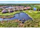 Luxury community with houses surrounding a pond and golf course at 4259 Whispering Oaks Dr, North Port, FL 34287